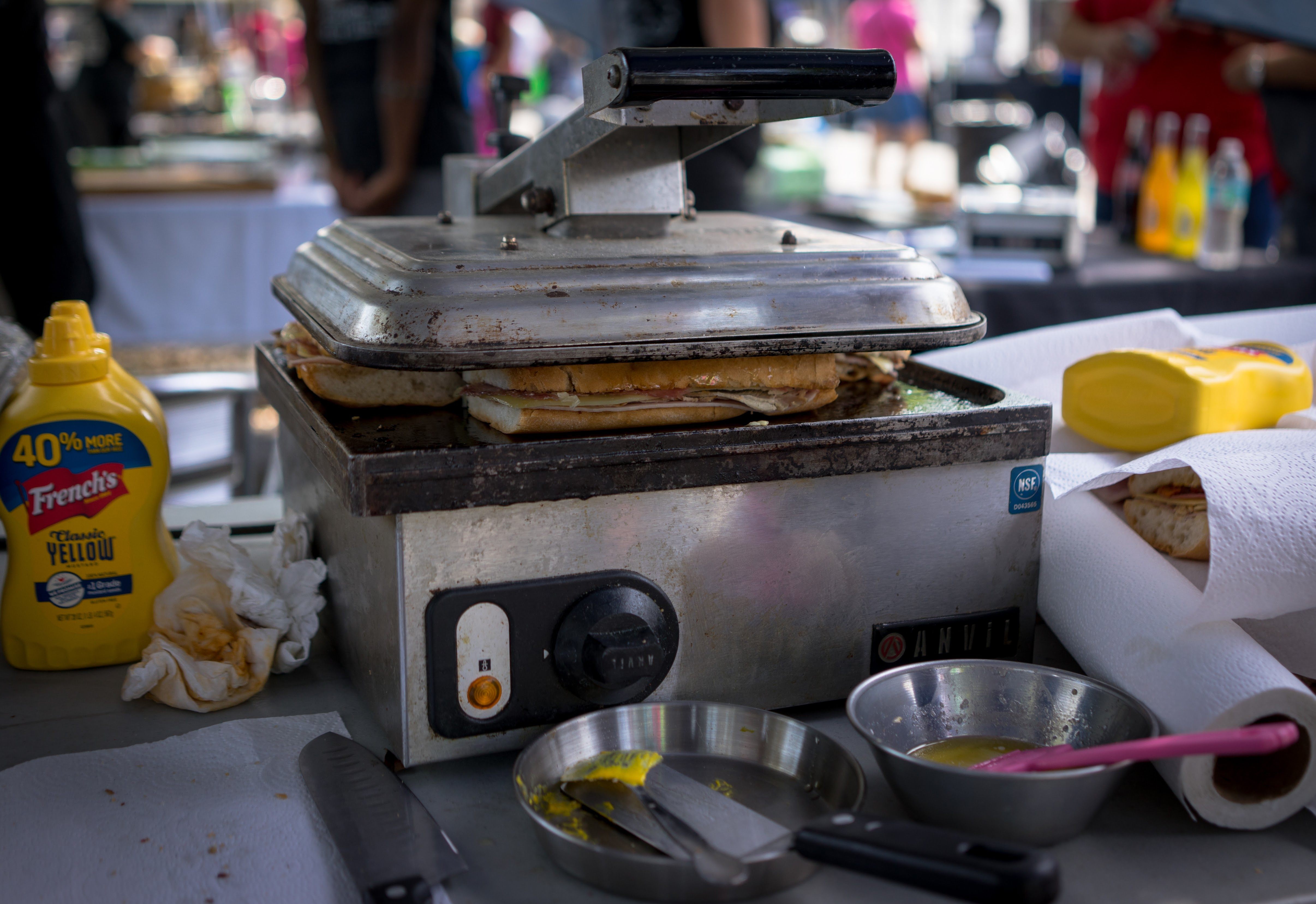 A crucial stage of the Cuban sandwich involves pressing on the plancha.