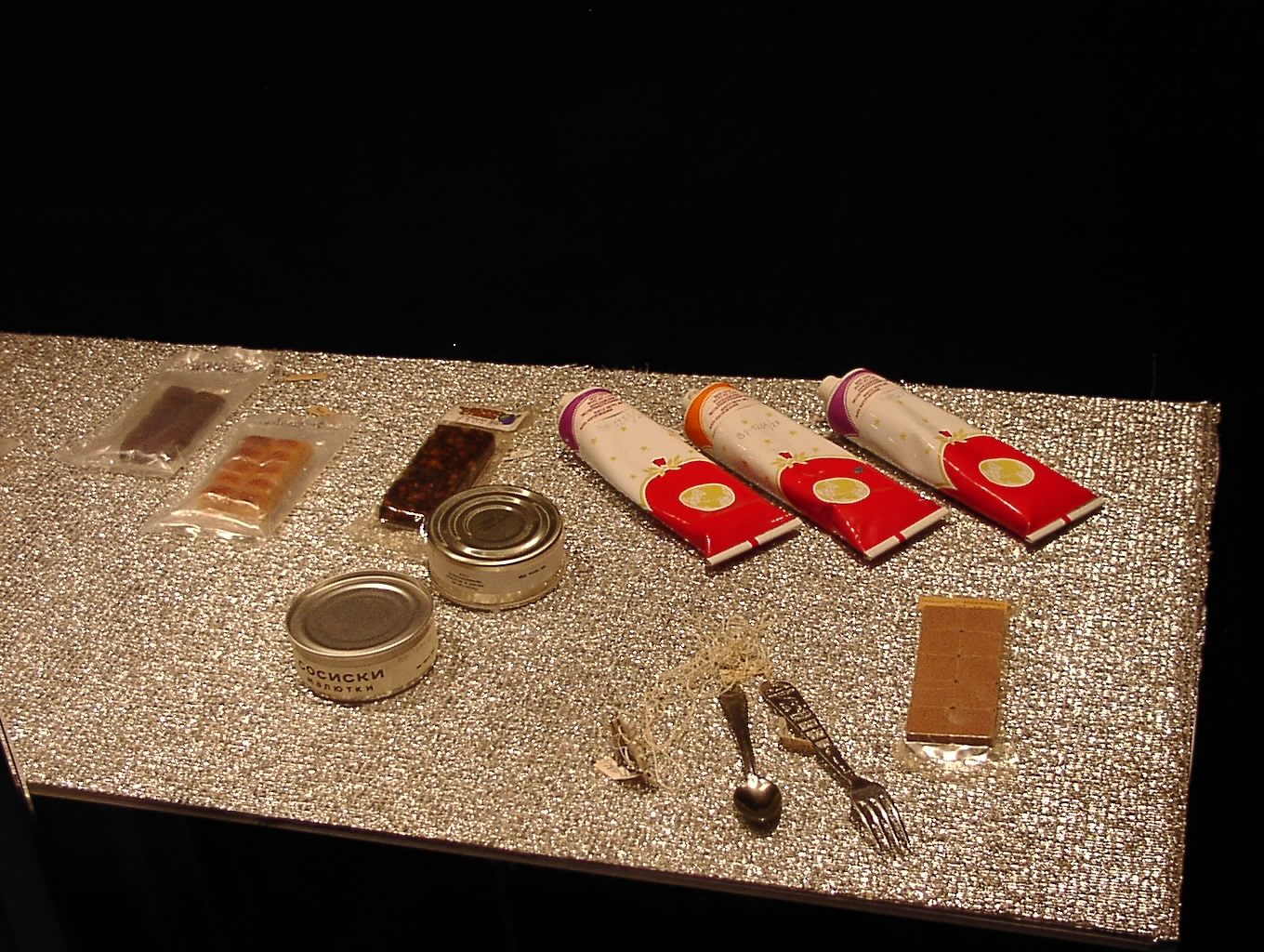 Russian space food is packaged in toothpaste-shaped tubes with packaging in block colors.