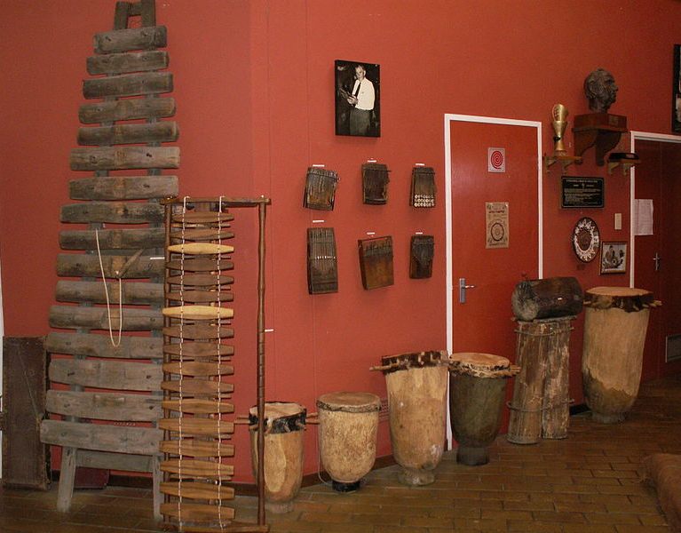 Inside ILAM, The akadinda (large xylophone), kalimbas on the wall, and a photo of Hugh Tracey.