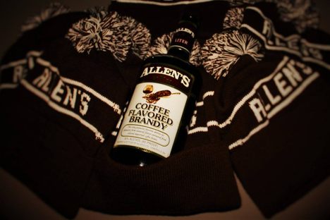 A bottle of Allen's among Allen's knitted hats. 