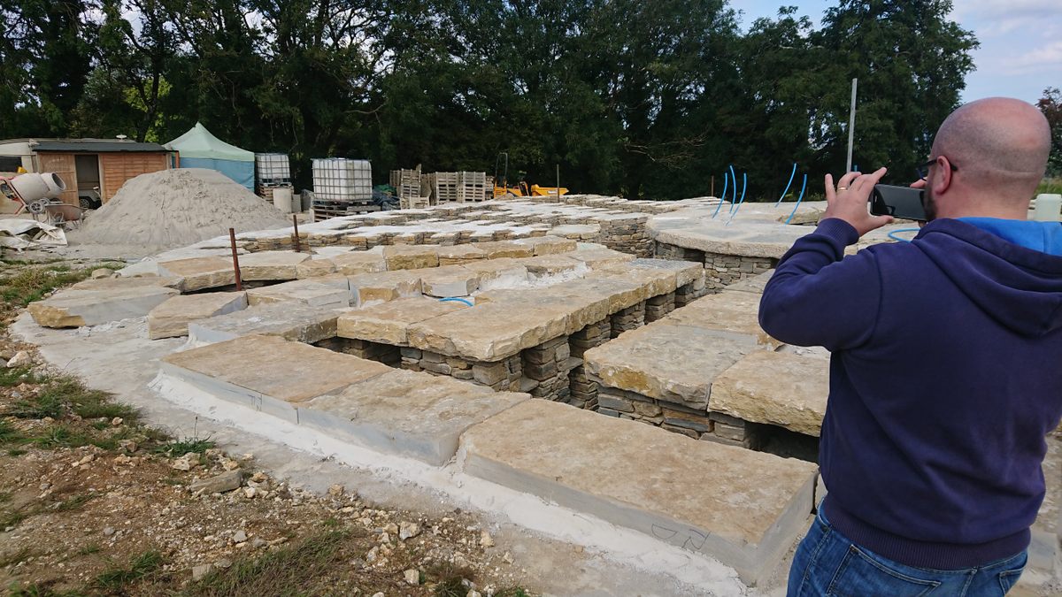 University of Glasgow researcher Andrew Watson surveys a modern barrow under construction.