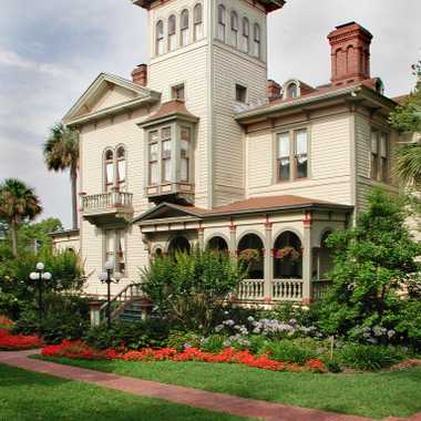 Located on a residential, tree-lined street, the home stands apart from its neighbors with grand, arched windows, arcaded galleries, and ornate piazzas on three sides.
