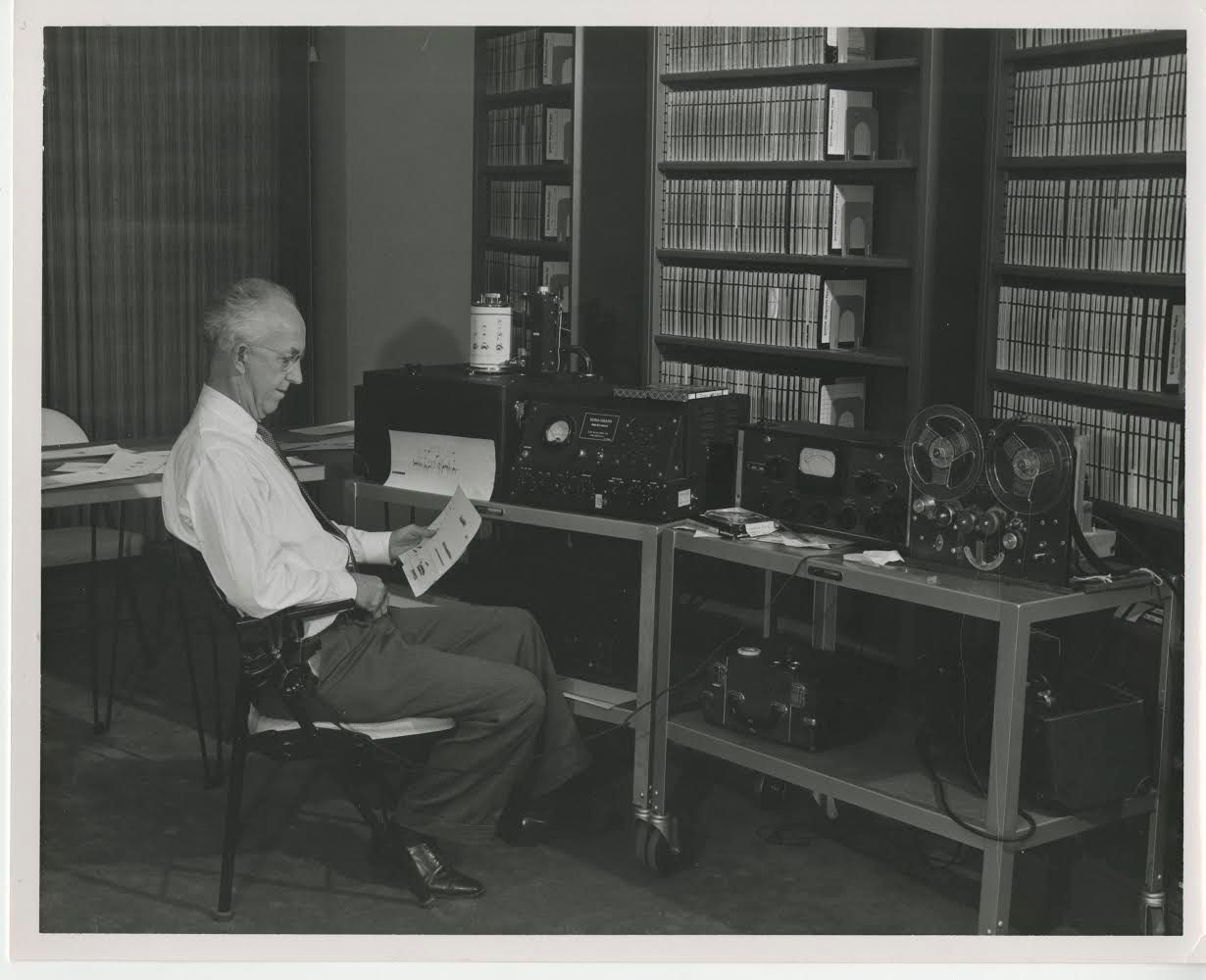 Ornithologist L. Irby Davis examines a spectrogram from an early Kay Elemetrics Sona-Graph, in the 1950s.