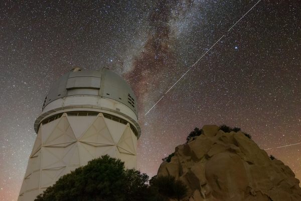The BlueWalker 3 satellite leaves a trail in the sky above the Nicholas U. Mayall 4-meter Telescope at Arizona's Kitt Peak National Observatory. Breaks in the trail are the result of image processing: Four 20-second exposures were stacked to create the shot.