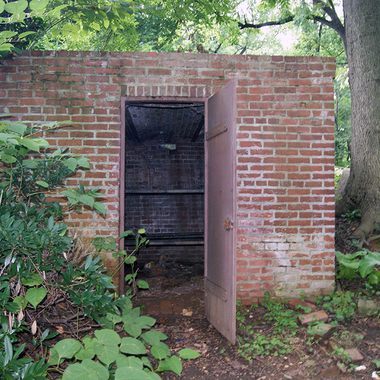 The heavy iron door is unlocked.