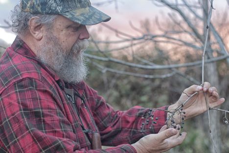 Marion revealing the bear-ravaged remains of a small cluster of wild grapes.