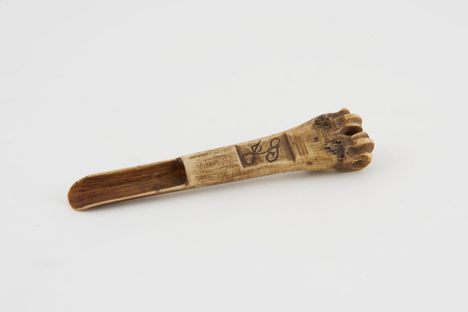 An apple scoop carved from a sheep's tibia, European, 19th century.