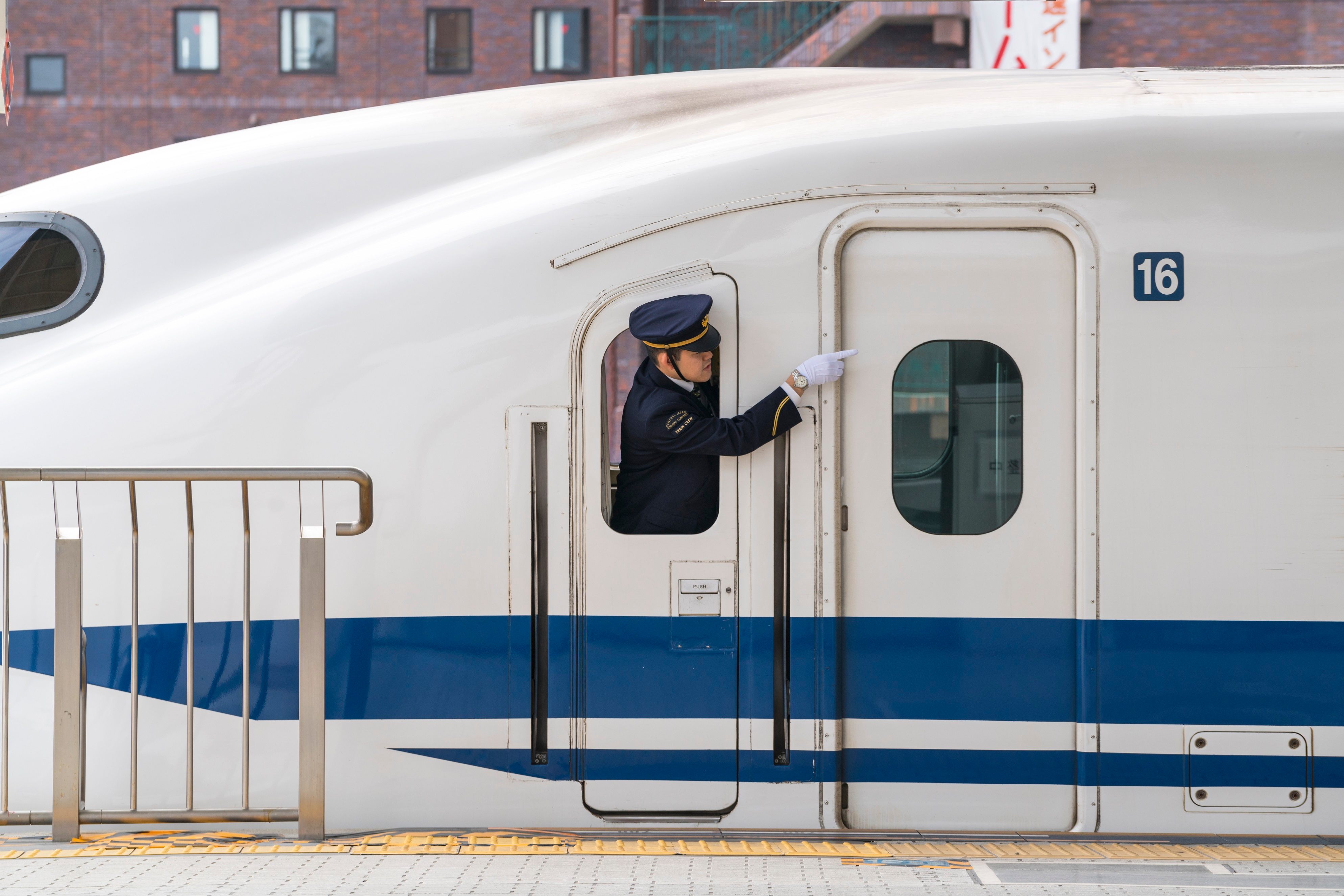 Guard on Shinkansen bullet train in Kyoto Station
