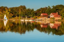 Jamaica Pond view across the water of the boat house and music building