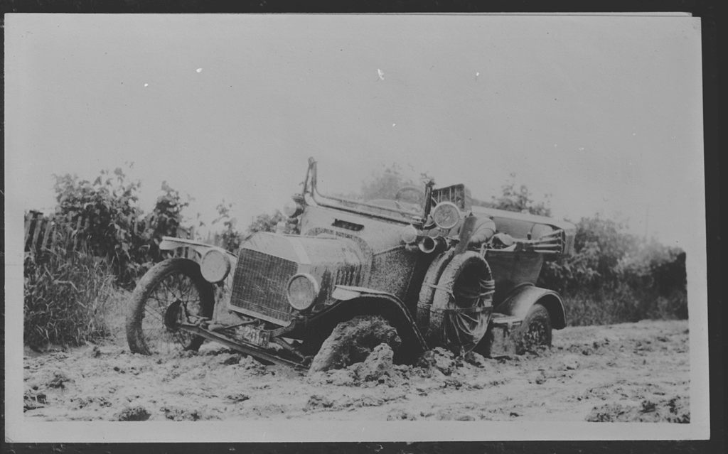 A car mired in mud, c. 1910.