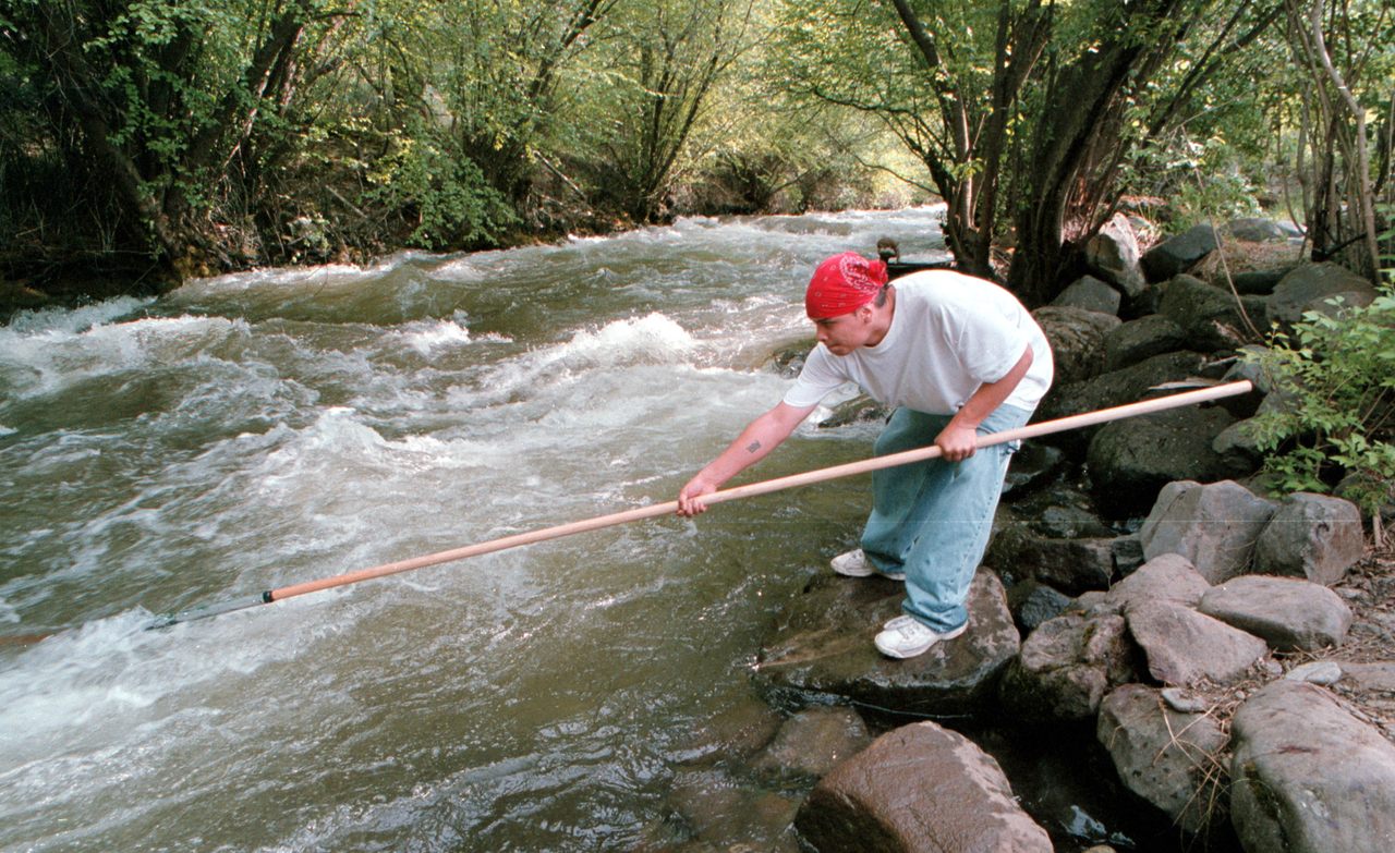 A member of the Nez Perce, Brian J. Pinkham, dipnets for Chinook salmon in Idaho in 2001. For the past several years, the tribe's climate change coordinator, Stefanie Krantz, has been conducting a vulnerability assessment and working on a climate adaptation plan.