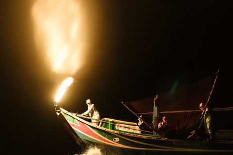 A fire-fishing boat lures sardines to the surface off the coast of Taiwan.