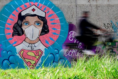 Artist Kai 'Uzey' Wohlgemuth depicted a nurse as Superwoman in Hamm, Germany, April 8, 2020.