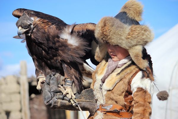 Aimoldir Dayanbek proudly displays her champion eagle at the 2020 Sagsai Eagle Hunting Festival. 