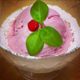Teaberry ice cream garnished with wintergreen leaves and a teaberry.