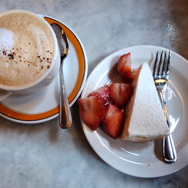 A cappuccino goes great with a slice of New York-style cheesecake.