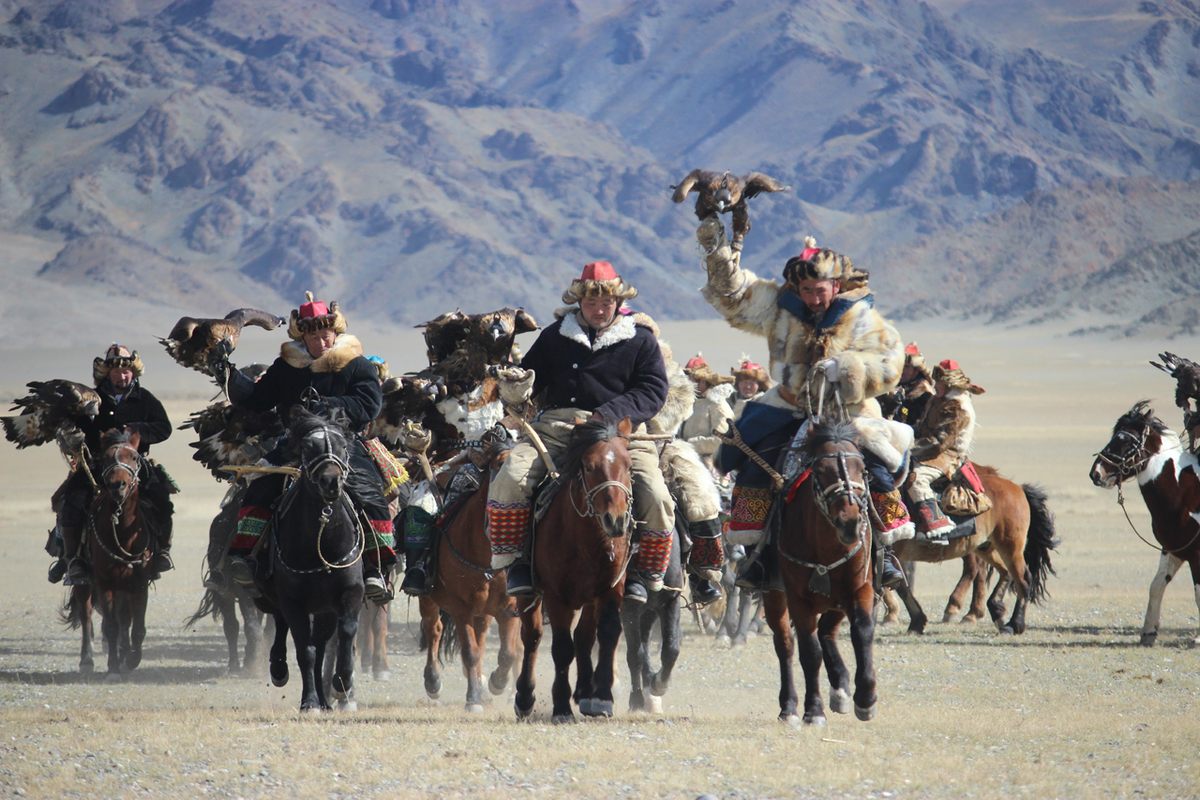 Eagle hunters start out the competition by showcasing their traditional attire, horses, and eagles.