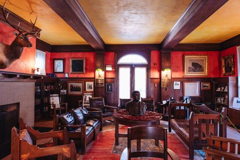 The lodge's interior features an eclectic mix of styles, from Arts and Crafts to early 20th-century neoclassical.