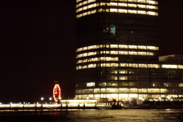 At night, dwarfed by the Goldman Sachs building. (Wikimedia Commons)