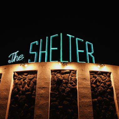 The Shelter lit up at night