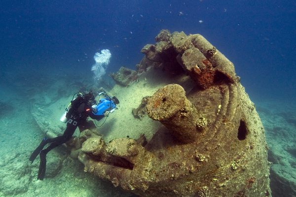 Wrecks stand to see a number of threats in a changing ocean. Here, NOAA diver John Brooks a ship off the coast of Hawaii. 