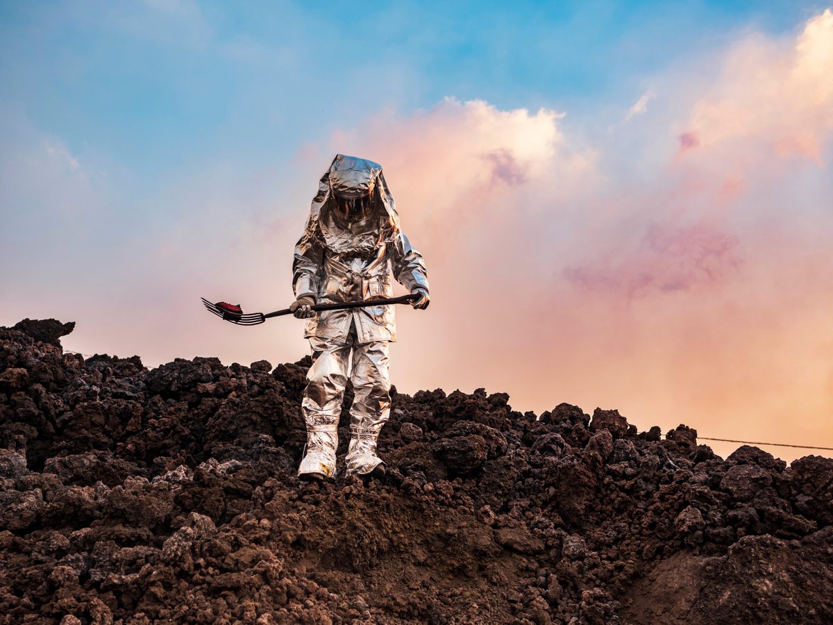 Seargent Armando Salazar, in a thermal suit, takes samples from volcanic slag still well over 500 degrees Fahrenheit.