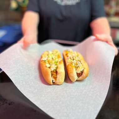 Order your dogs topped with chili, mustard, and onions.