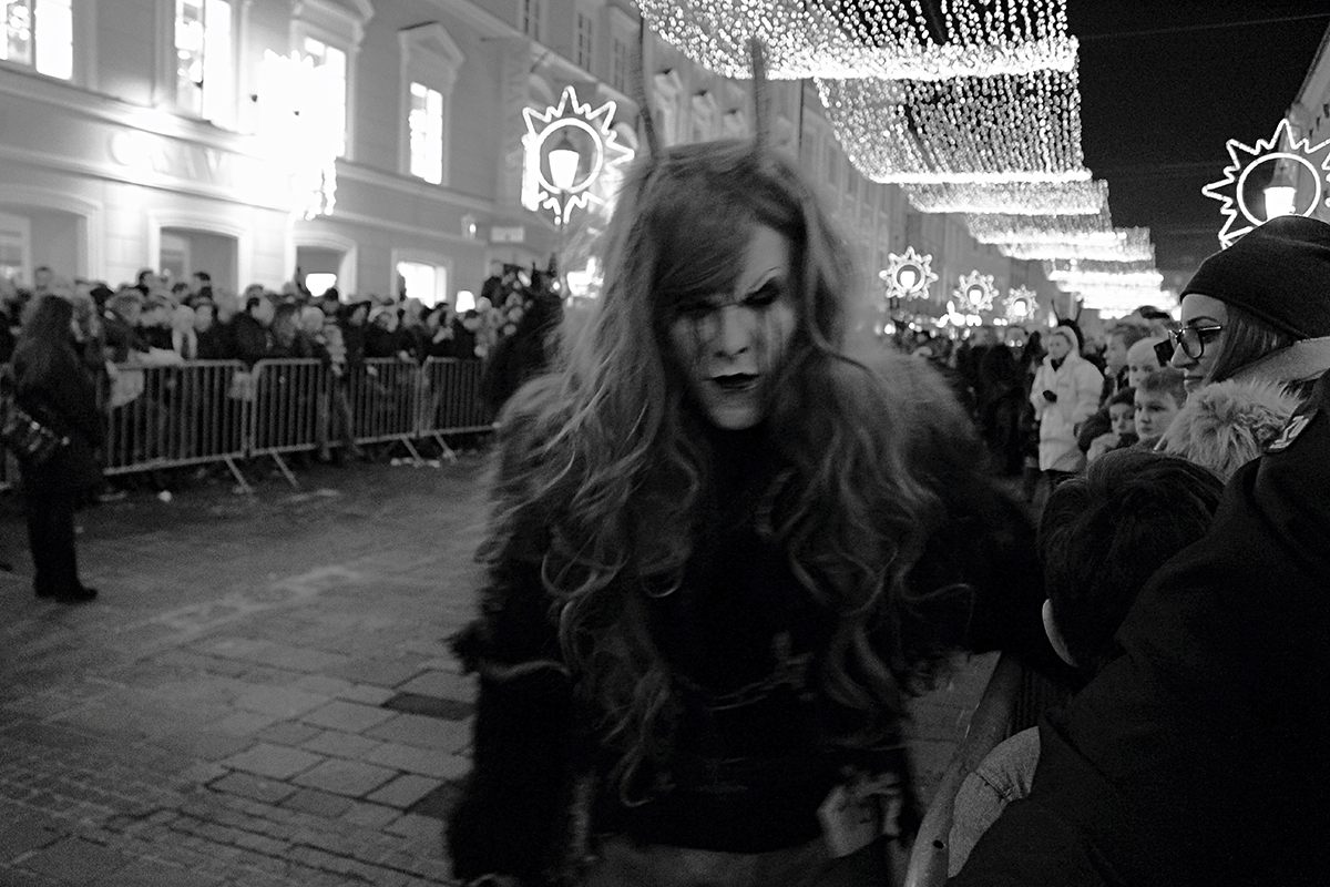 Women typically do not play Krampus, though some troupes allow it. This woman is likely personifying Frau Perchta, the witch leader of all wintertime spirits.