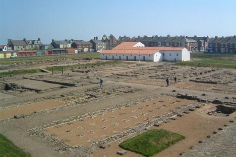Reconstructed barracks buildings and  foundations of graneries