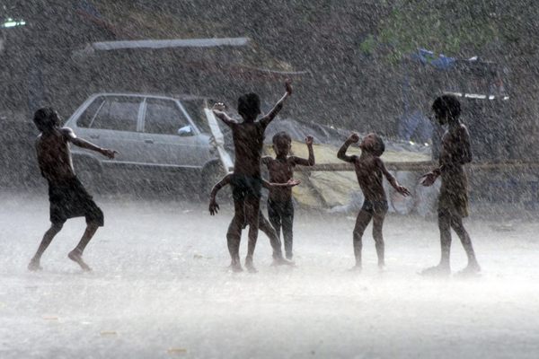 Children play in the monsoon rains that pour down on the north Indian state of Uttar Pradesh every year from late July till September.