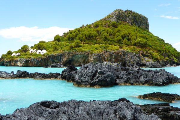 The eastern side of the island, the closest to the coast, the abandoned structures can be seen on the left.