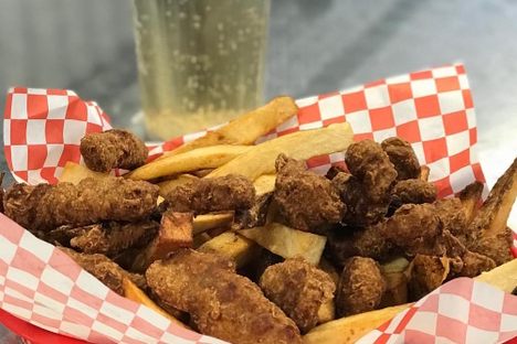 A basket of finger steaks and fries.
