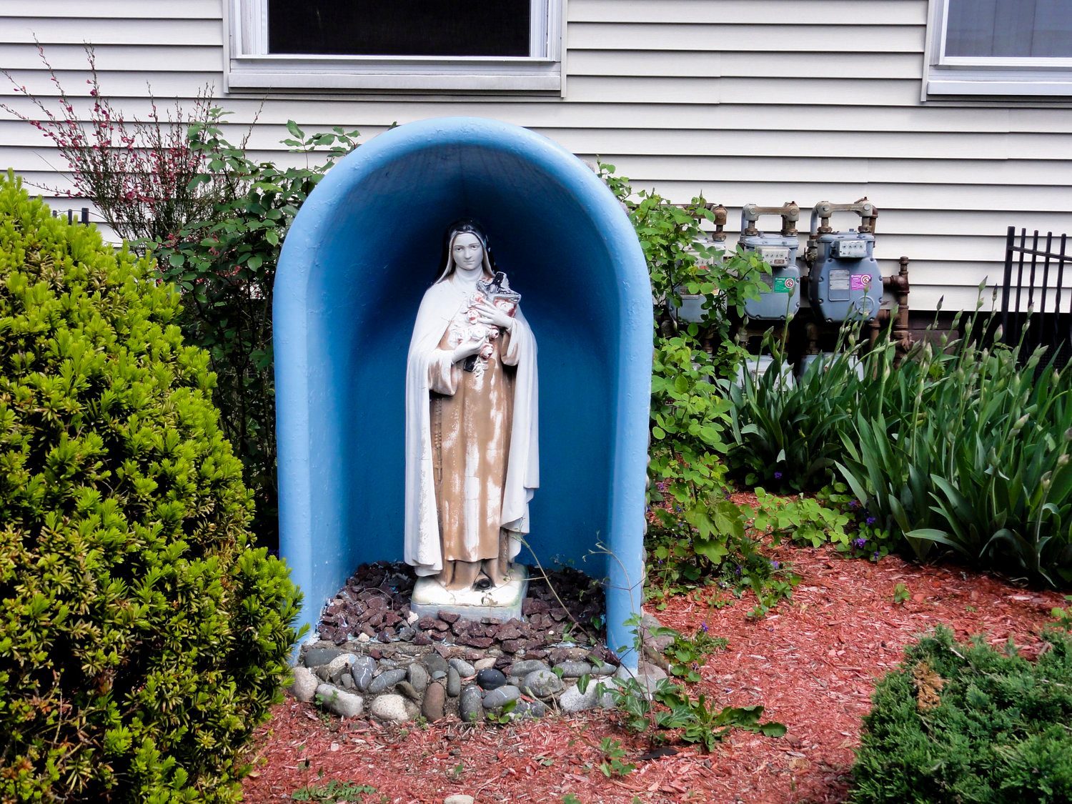 Saint Therese of Lisieux in a bathtub, in front of a house in Somerville, MA.*