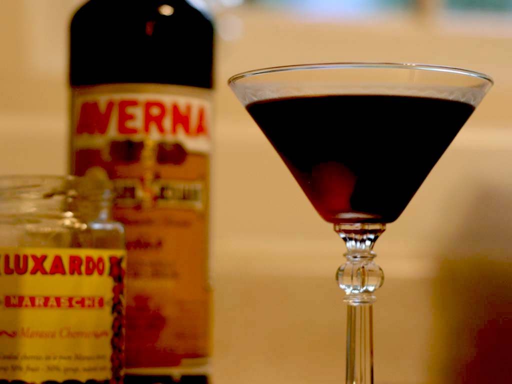 A Luxardo cherry is the centerpiece of this cocktail, known as a Black Manhattan.