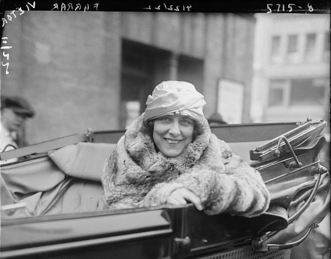 In the open cars of the early 20th century, it was important to bundle up.