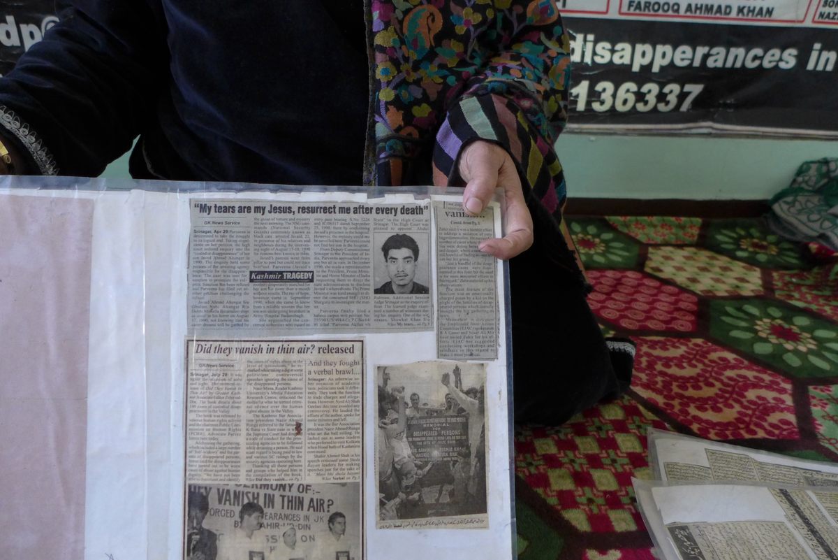 Ahangar shows a newspaper clipping of her 16-year-old son, Javaid, who was taken away by security forces in 1990.
