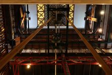 Leather belts running from the generator to the fans on the top floor.