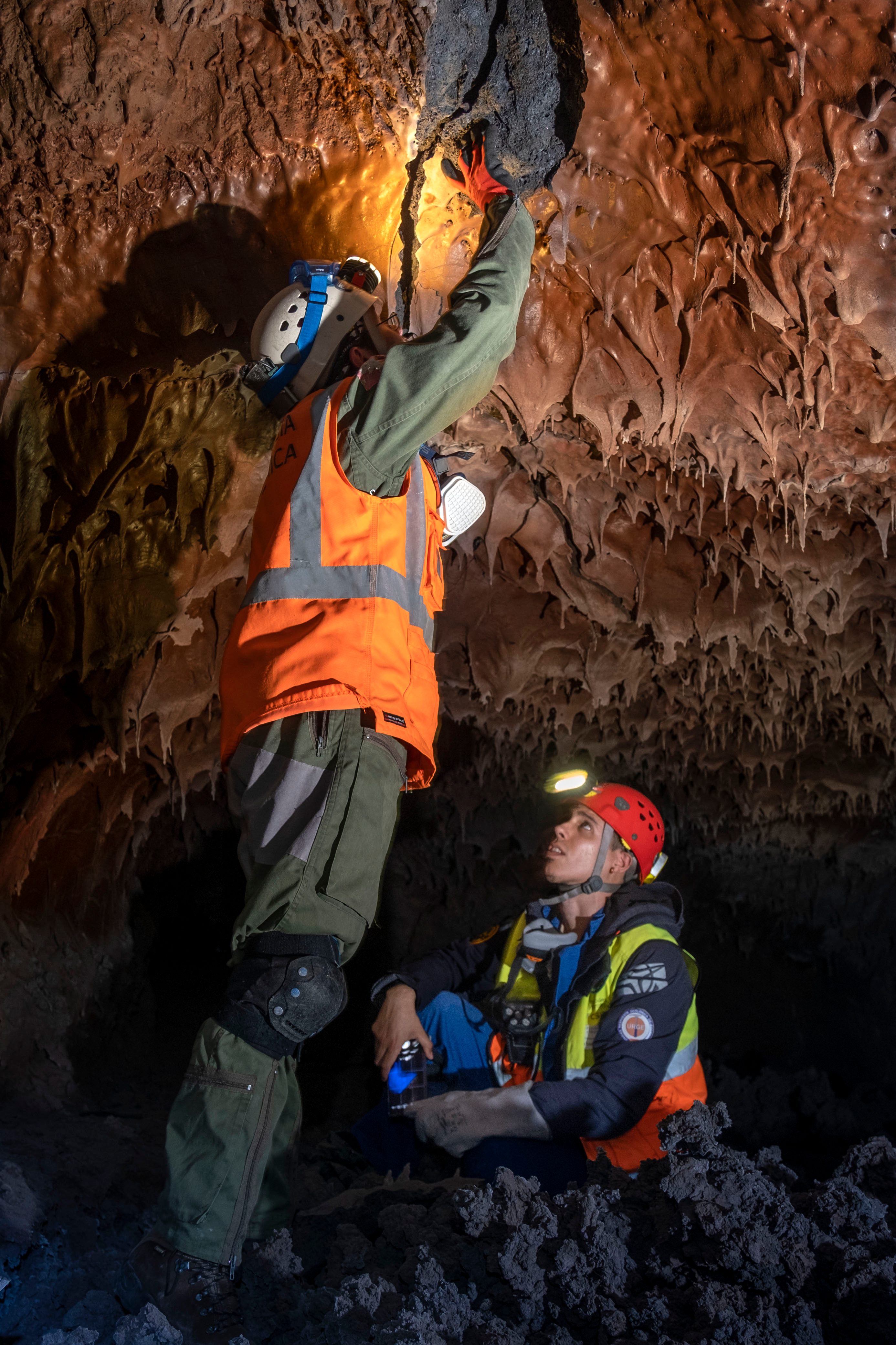 Researchers examine ceiling formations in the Red Cave. 