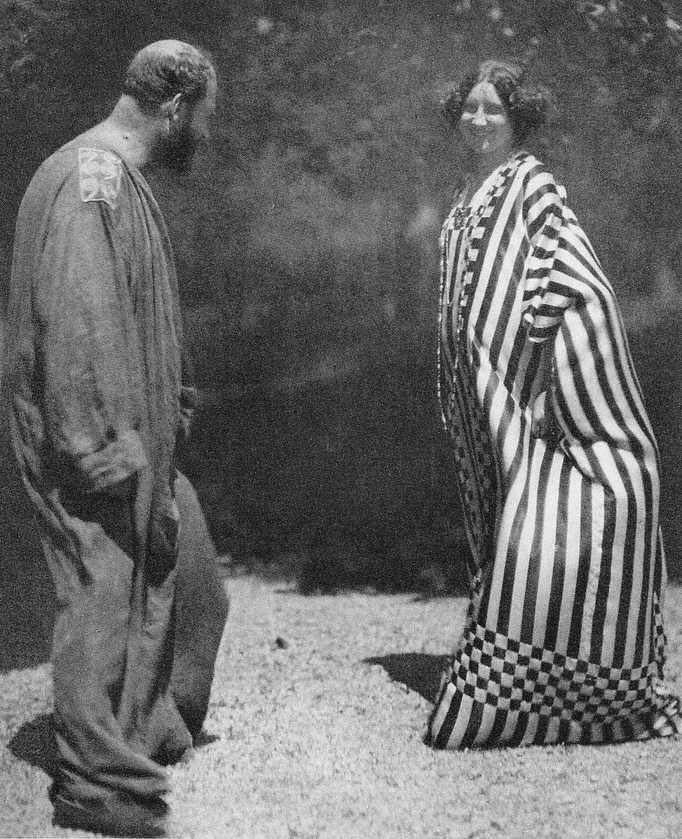 Heinrich Böhler took this 1909 photo of Emilie Flöge and Gustav Klimt posing in Flöge's dress designs. Flöge and Klimt were lifelong friends. When Klimt suffered from a sudden stroke, his last words were, "Emilie must come."