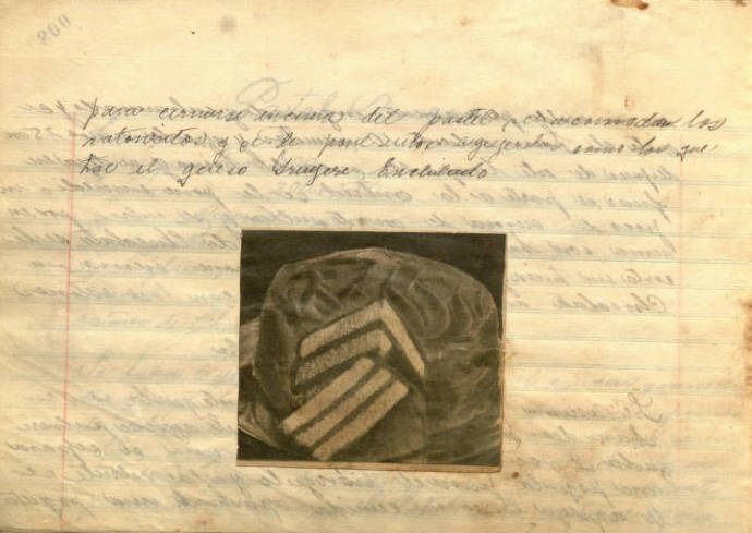 This handwritten recipe book also features pasted illustrations from magazines and newspapers.