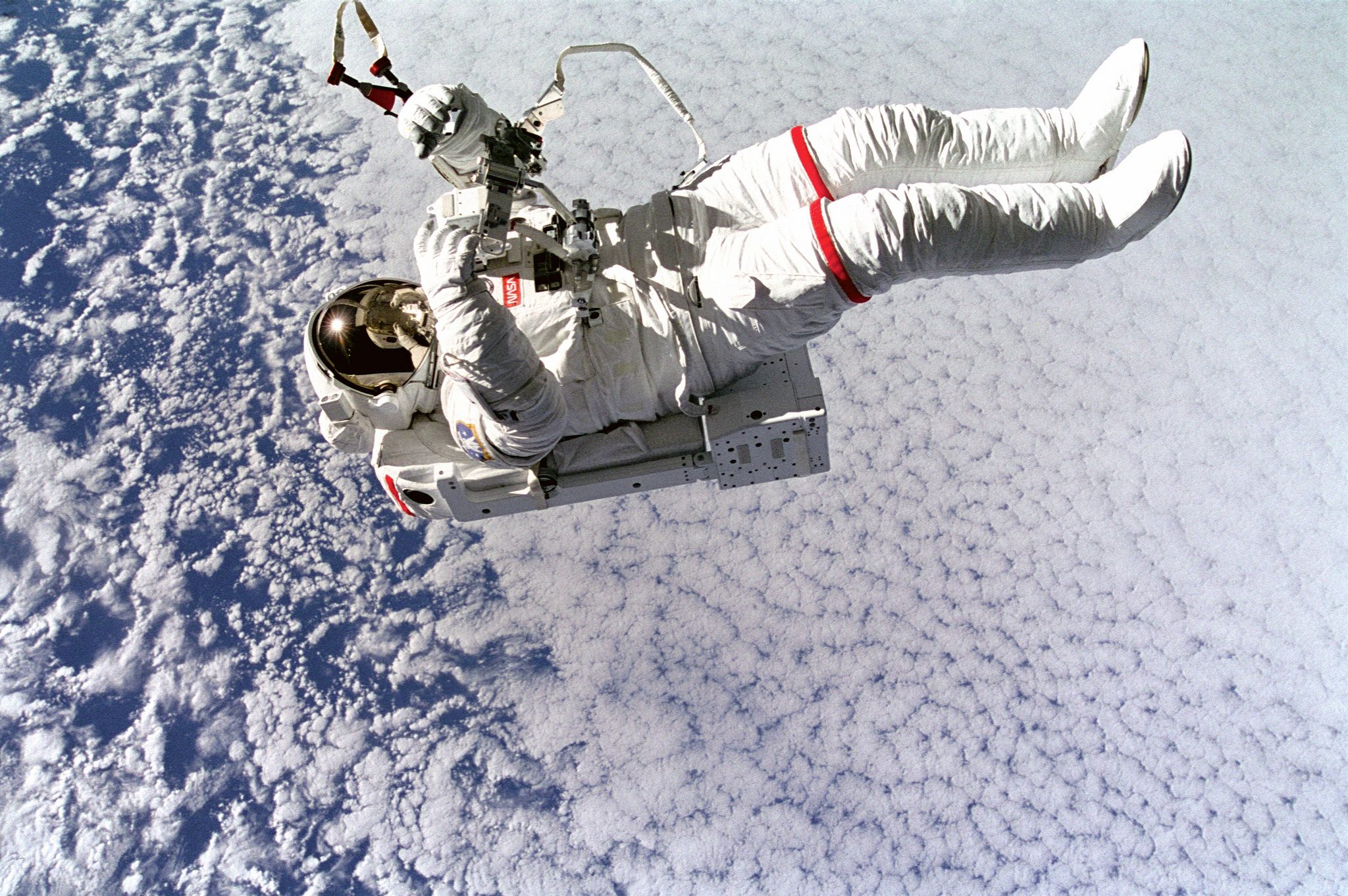   (September 16, 1994) Backdropped against clouds 130 nautical miles below, astronaut Mark C. Lee floats freely without tethers as he tests the new Simplified Aid for EVA Rescue (SAFER) system.