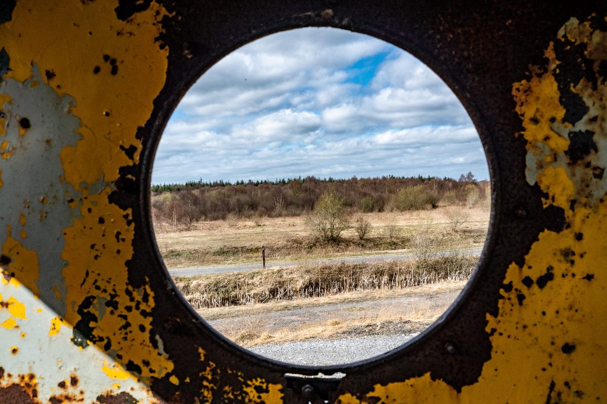 A view of Lough Boora Discovery Park from inside the rusting yellow train-turned-sculpture called “Sky Train.”