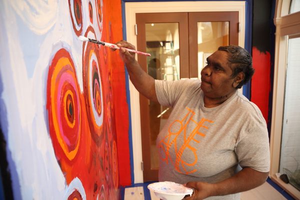 Barbara Moore working on Ngayuku Ngura mural.
