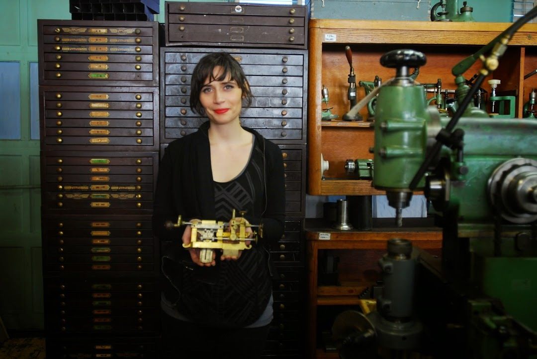 Nico Cox, surrounded by antiquarian horology.