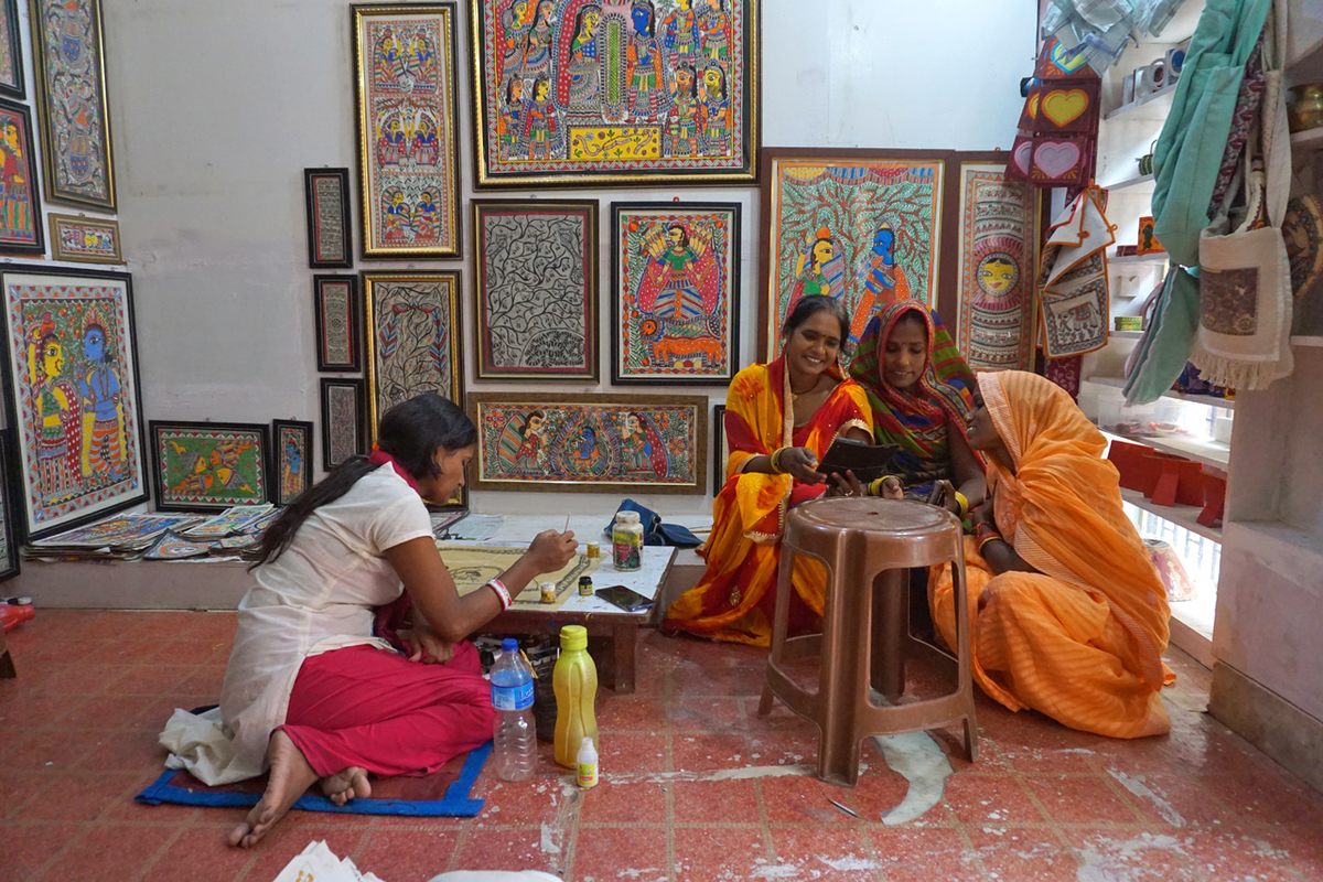 Artist Deepa Karn (far left) paints during a workshop in Janakpur. Training centers for Mithila artists now dot the region.