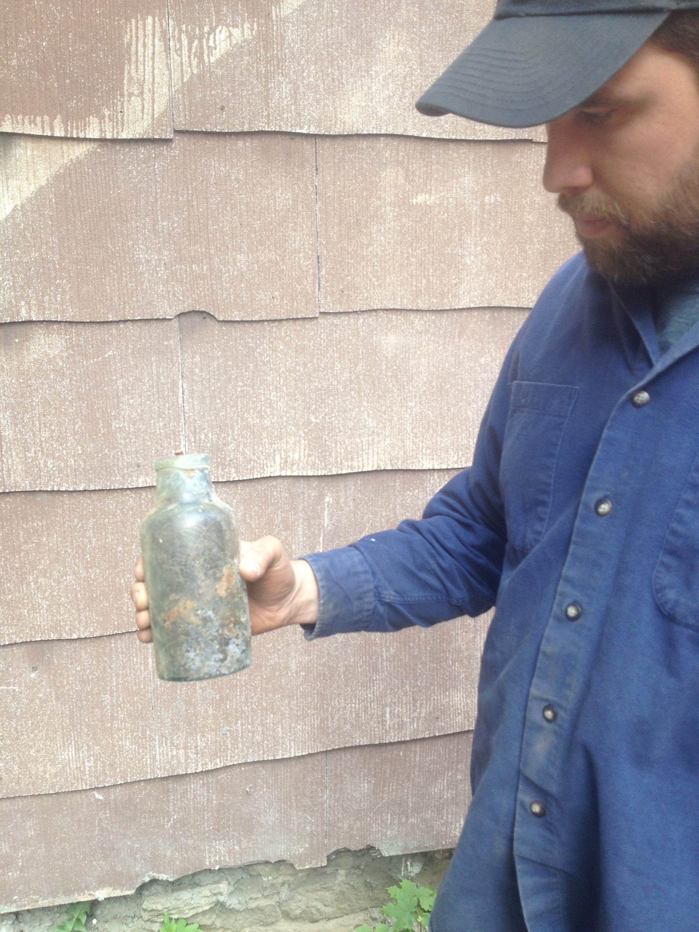 Joseph Bagley holds a bottle that once belonged to a 1920s Irish family. 