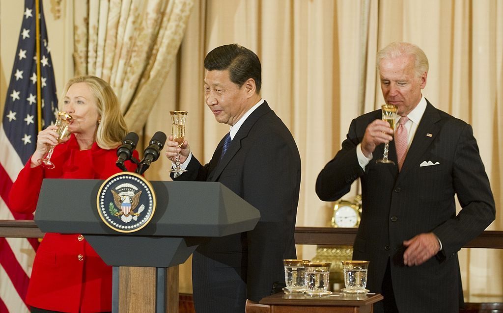 Xi Jinping, Joe Biden, and Hillary Clinton hold a toast at a State Department lunch in February 2012.