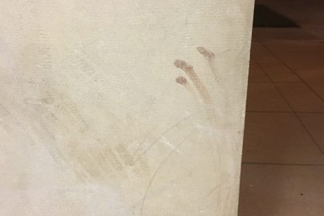 Finger streaks on a nearby pillar at the same entrance.