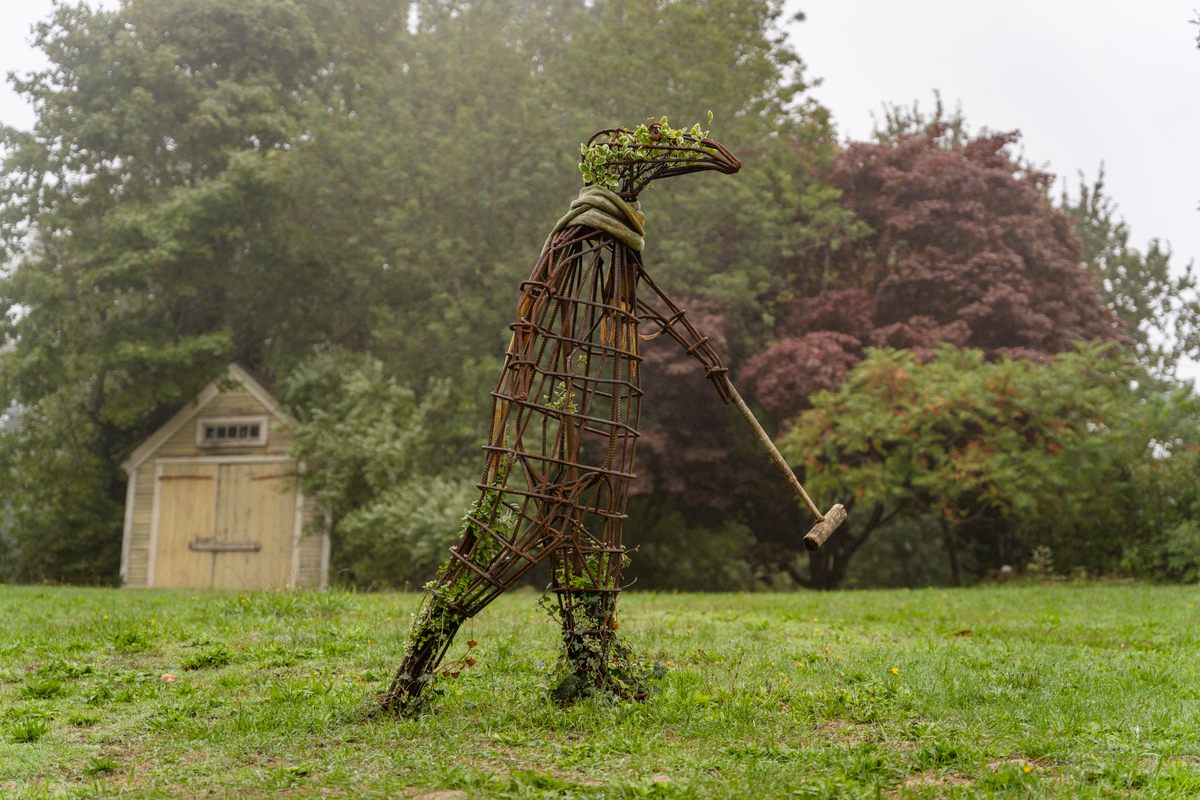 A metal sculpture of <em>The Doubtful Guest</em> in the backyard of the Edward Gorey House.