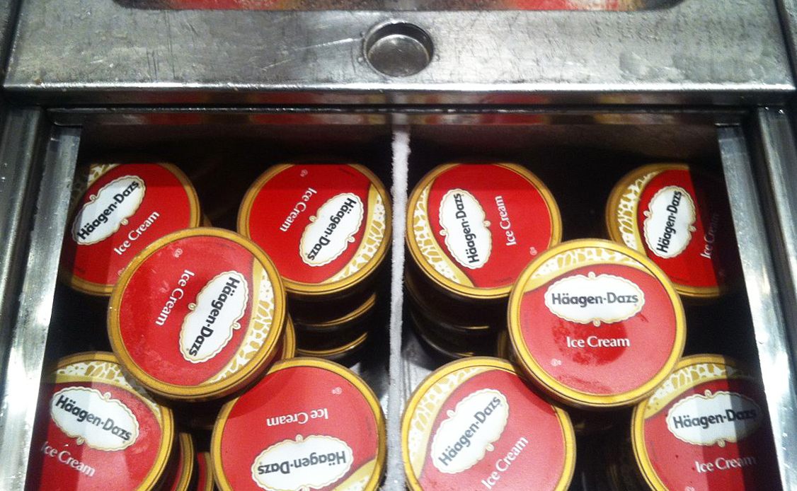 Tubs of Häagen-Dazs in a freezer.